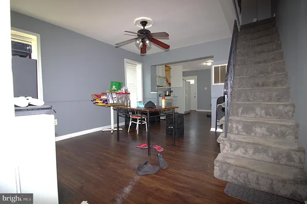 a dining room with furniture a fireplace and wooden floor