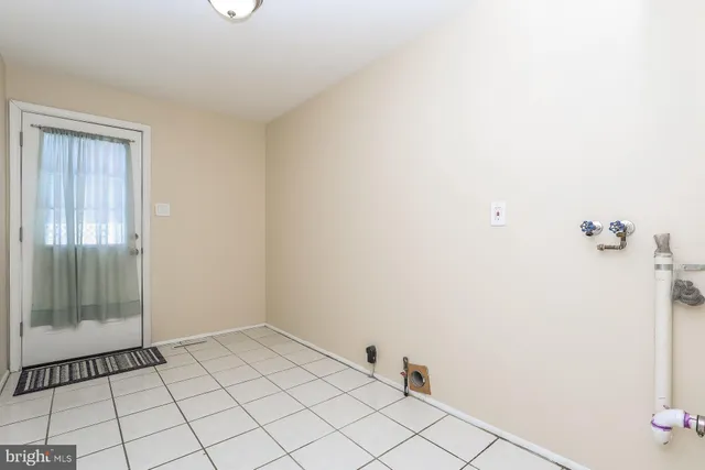 a kitchen with wooden floors and refrigerator