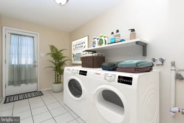 a kitchen with stainless steel appliances kitchen island granite countertop a stove a sink dishwasher a dining table and chairs with wooden floor