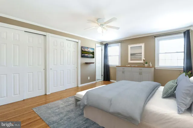 a living room with furniture a flat screen tv and a large window