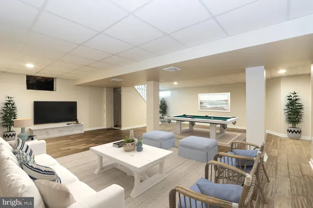 a room with pool table and chairs