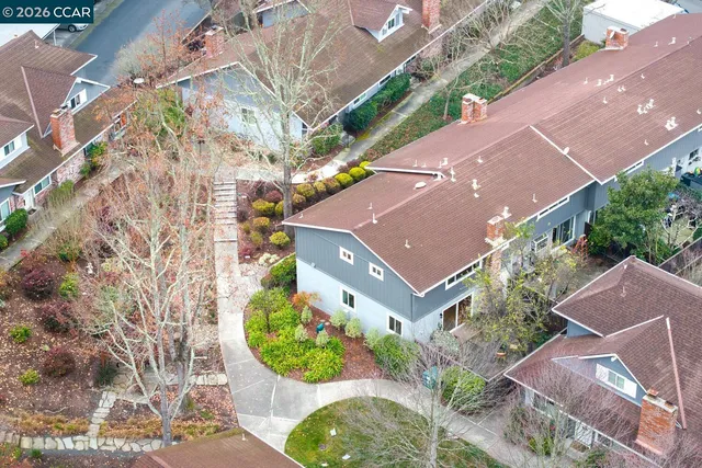 an aerial view of a house with a yard