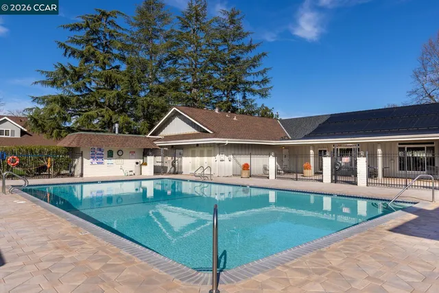 a view of a lake with a bench and trees around