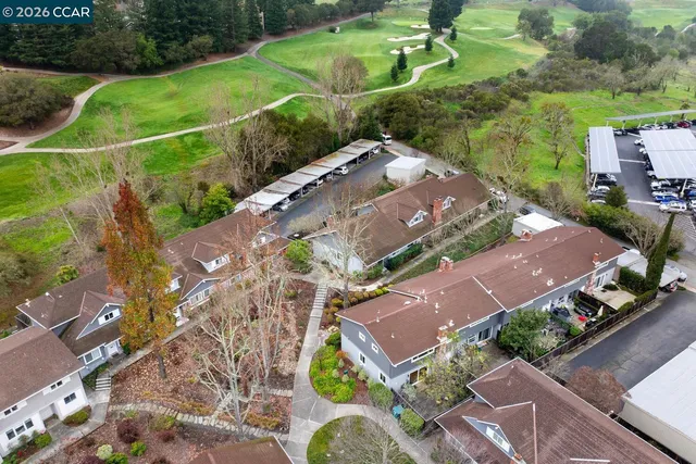 a sign board with tree in the background