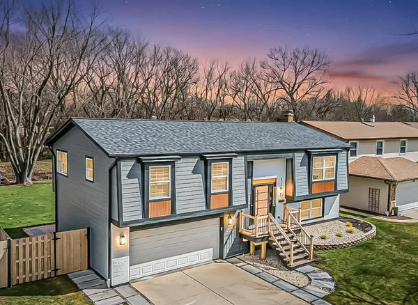 a view of a house with backyard and sitting area