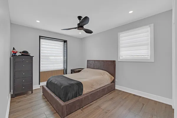 a bedroom with a bed and wooden floor