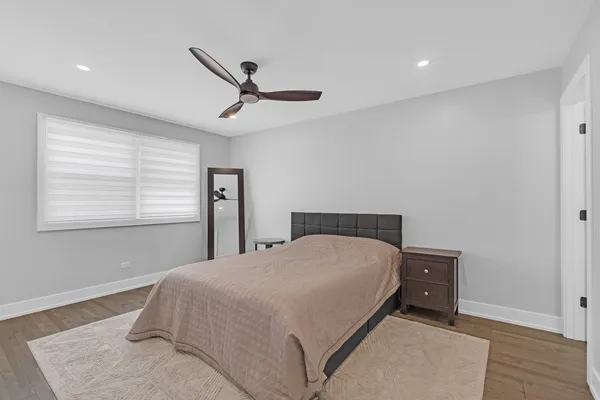 a bedroom with a large bed and a window