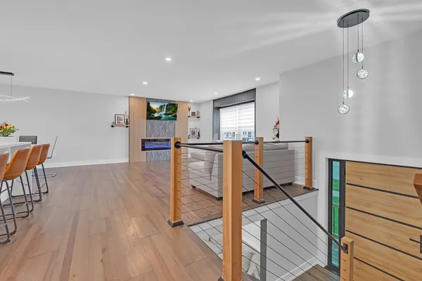 a view of a hallway with furniture and wooden floor
