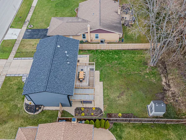 an aerial view of a house with a yard