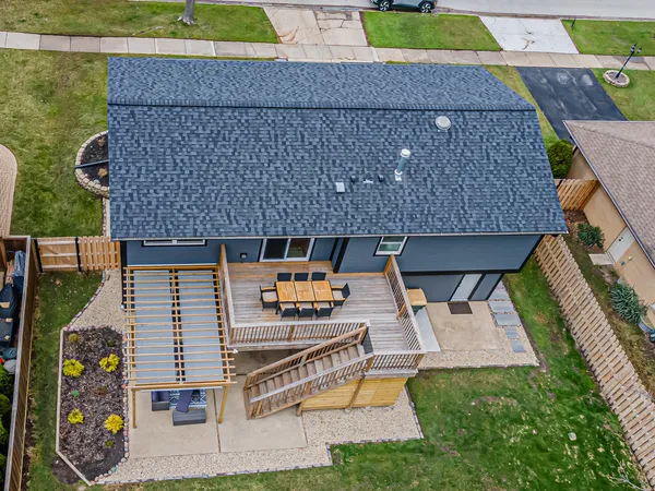a view of a house with a yard deck and a patio