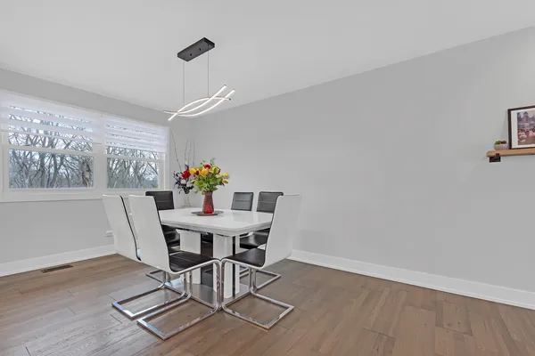 a view of a dining room with furniture and a potted plant