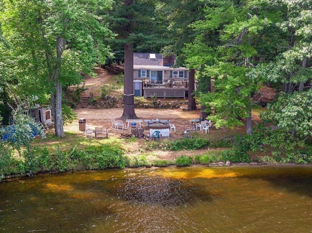 659 Reservoir Road Lunenburg, MA 01462 - Photo 2 of 41 a view of a house with a yard and a large tree front of it