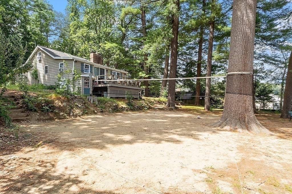 659 Reservoir Road Lunenburg, MA 01462 - Photo 21 of 41 a view of a house with backyard and trees