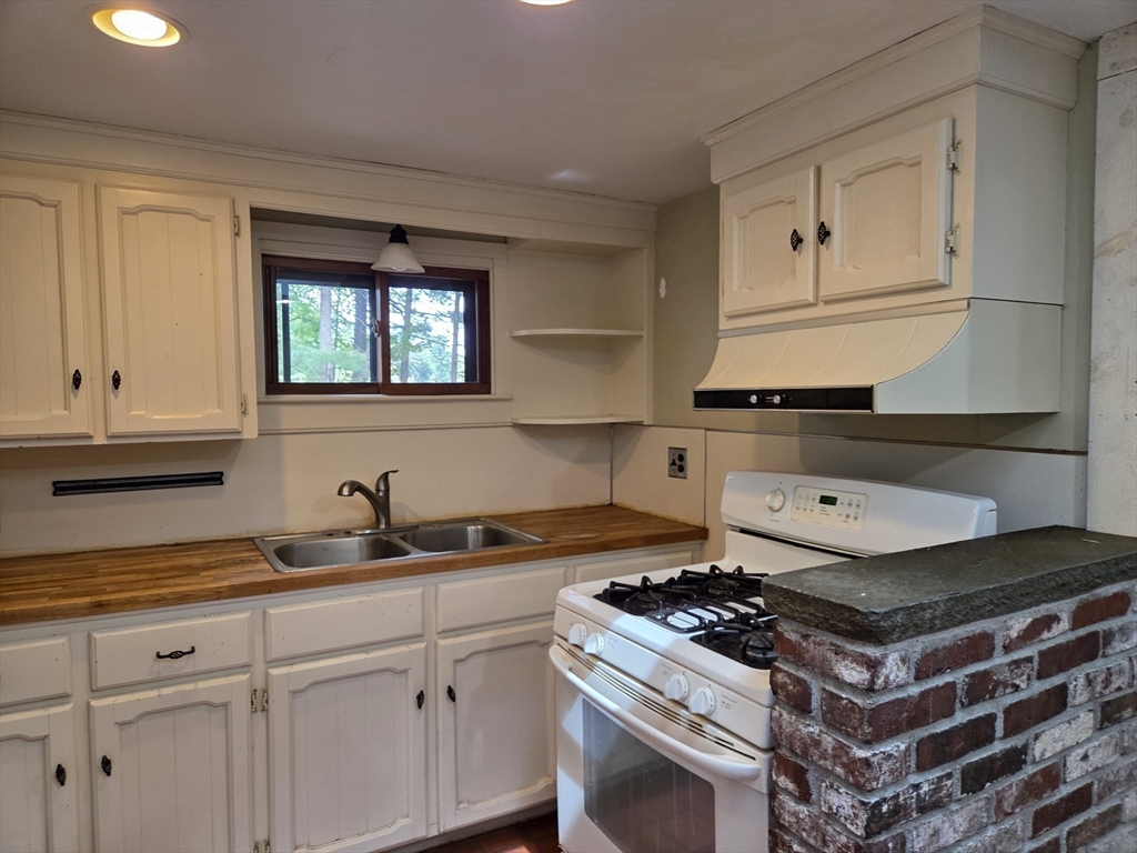 659 Reservoir Road Lunenburg, MA 01462 - Photo 6 of 41 a stove top oven sitting inside of a kitchen