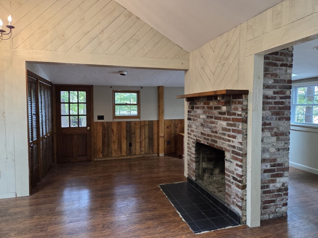 659 Reservoir Road Lunenburg, MA 01462 - Photo 9 of 41 a view of an empty room with wooden floor fireplace and a window