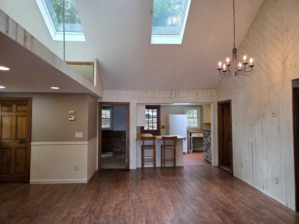 659 Reservoir Road Lunenburg, MA 01462 - Photo 10 of 41 an empty room with wooden floor and windows