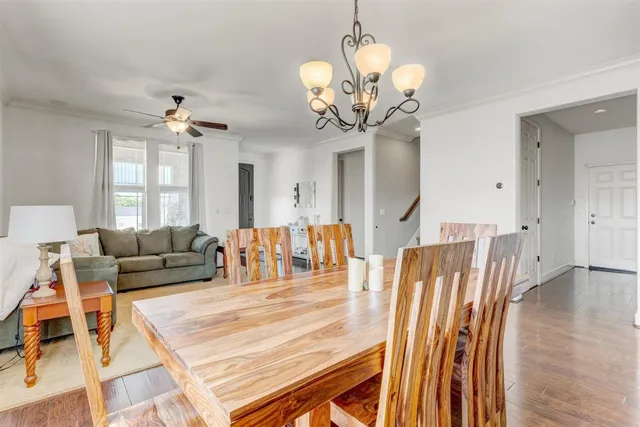 a living room with furniture dining area and a chandelier