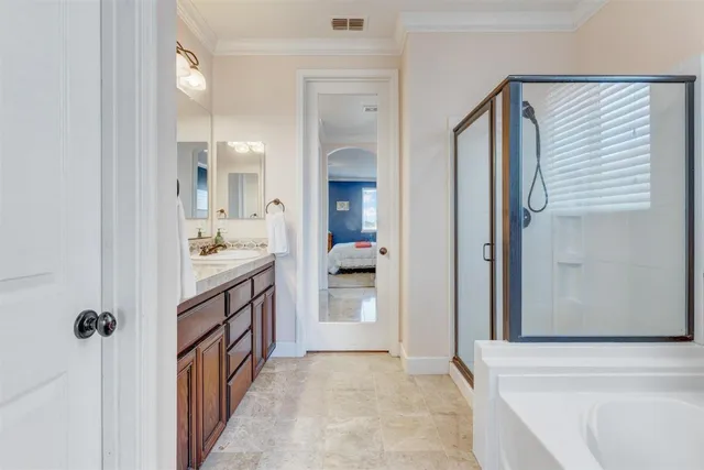 a en suite bathroom with a tub sink and mirror