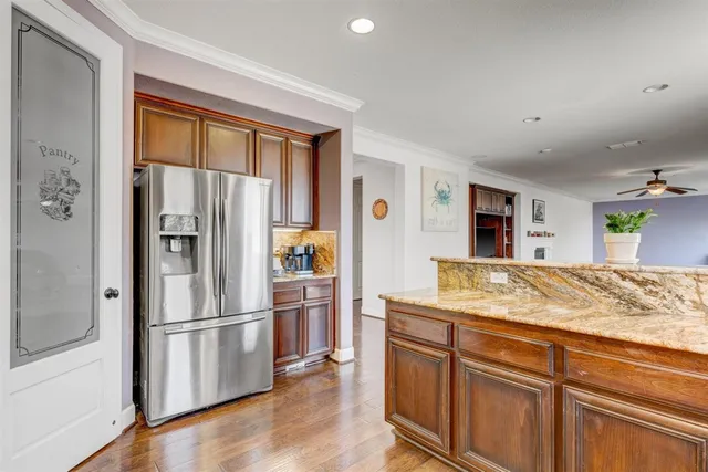 a kitchen with stainless steel appliances granite countertop a refrigerator and a sink