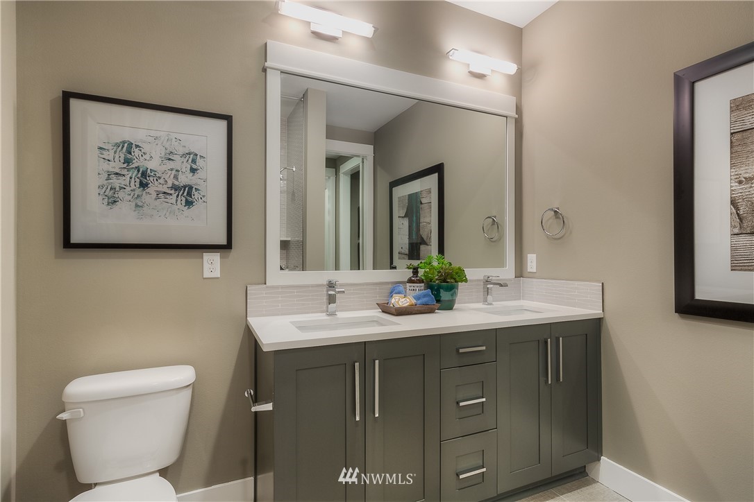 21803 34th Drive Southeast, Unit 18 Bothell, WA 98021 - Photo 22 of 25 a bathroom with a toilet sink and mirror