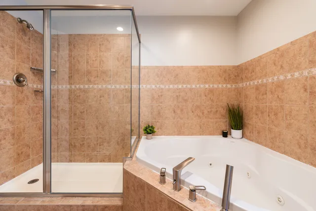 a bathroom with a bathtub and a shower