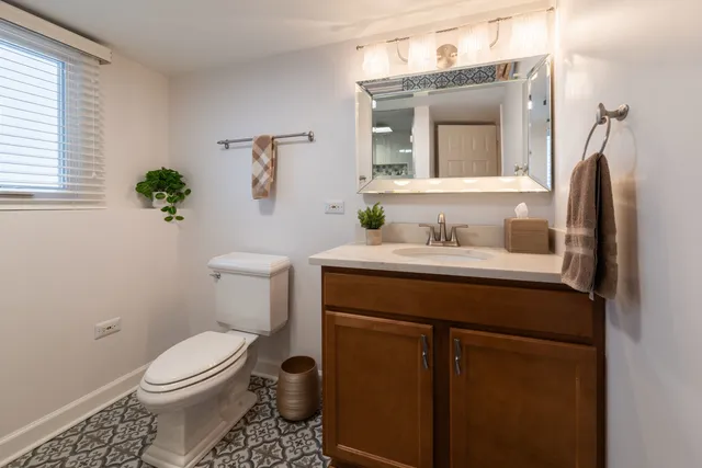 a bathroom with a sink vanity and toilet
