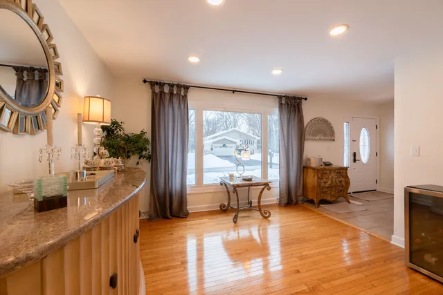 a very nice looking living room with a large window and dining chair
