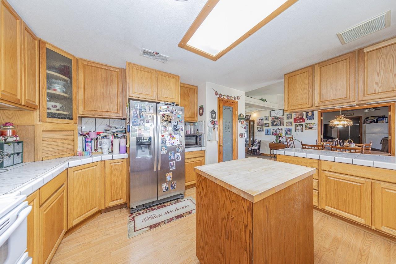 35095 Rough Rider Way Raymond, CA 93653 - Photo 18 of 57 a kitchen with stainless steel appliances granite countertop a refrigerator a stove and a sink with cabinets