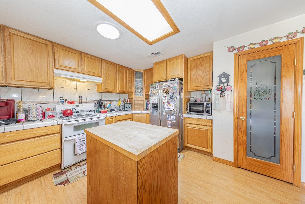 35095 Rough Rider Way Raymond, CA 93653 - Photo 21 of 57 a kitchen with a refrigerator and a sink