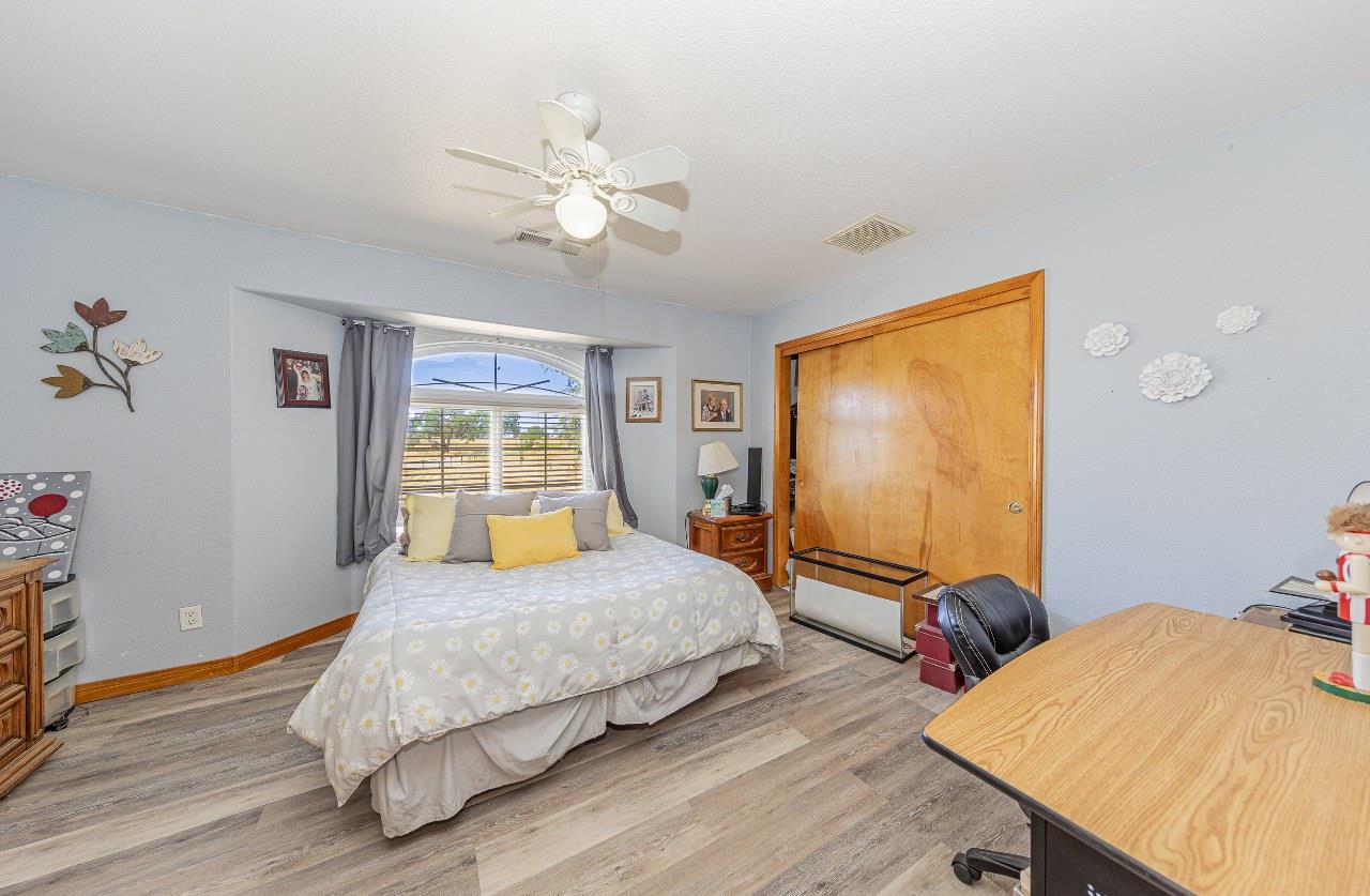 35095 Rough Rider Way Raymond, CA 93653 - Photo 27 of 57 a bedroom with a bed and a flat screen tv