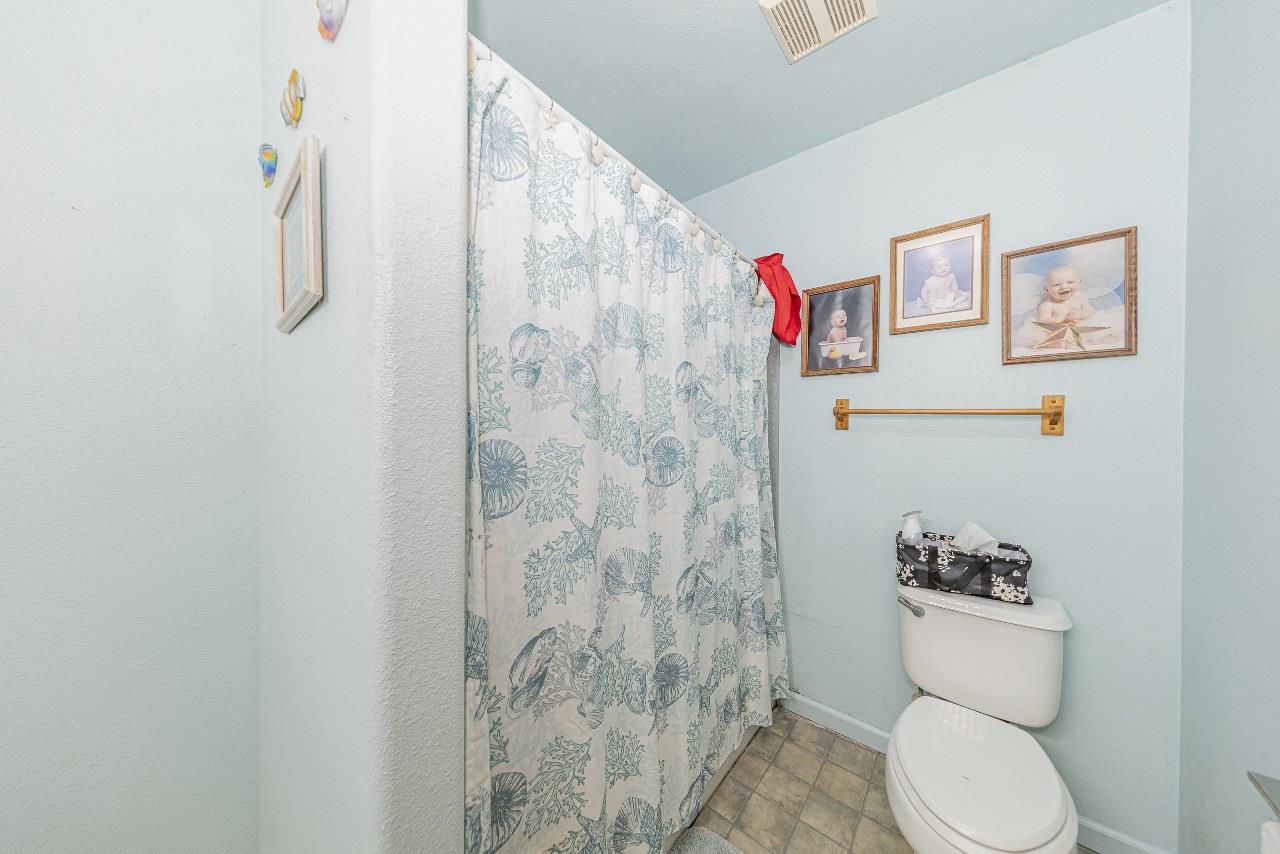 35095 Rough Rider Way Raymond, CA 93653 - Photo 30 of 57 a white toilet sitting next to a bathroom sink