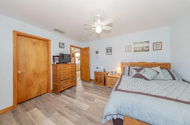 a bedroom with a bed and wooden floor