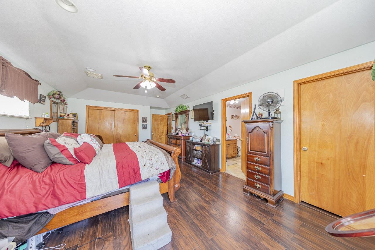 35095 Rough Rider Way Raymond, CA 93653 - Photo 35 of 57 a bedroom with a bed and wooden floor