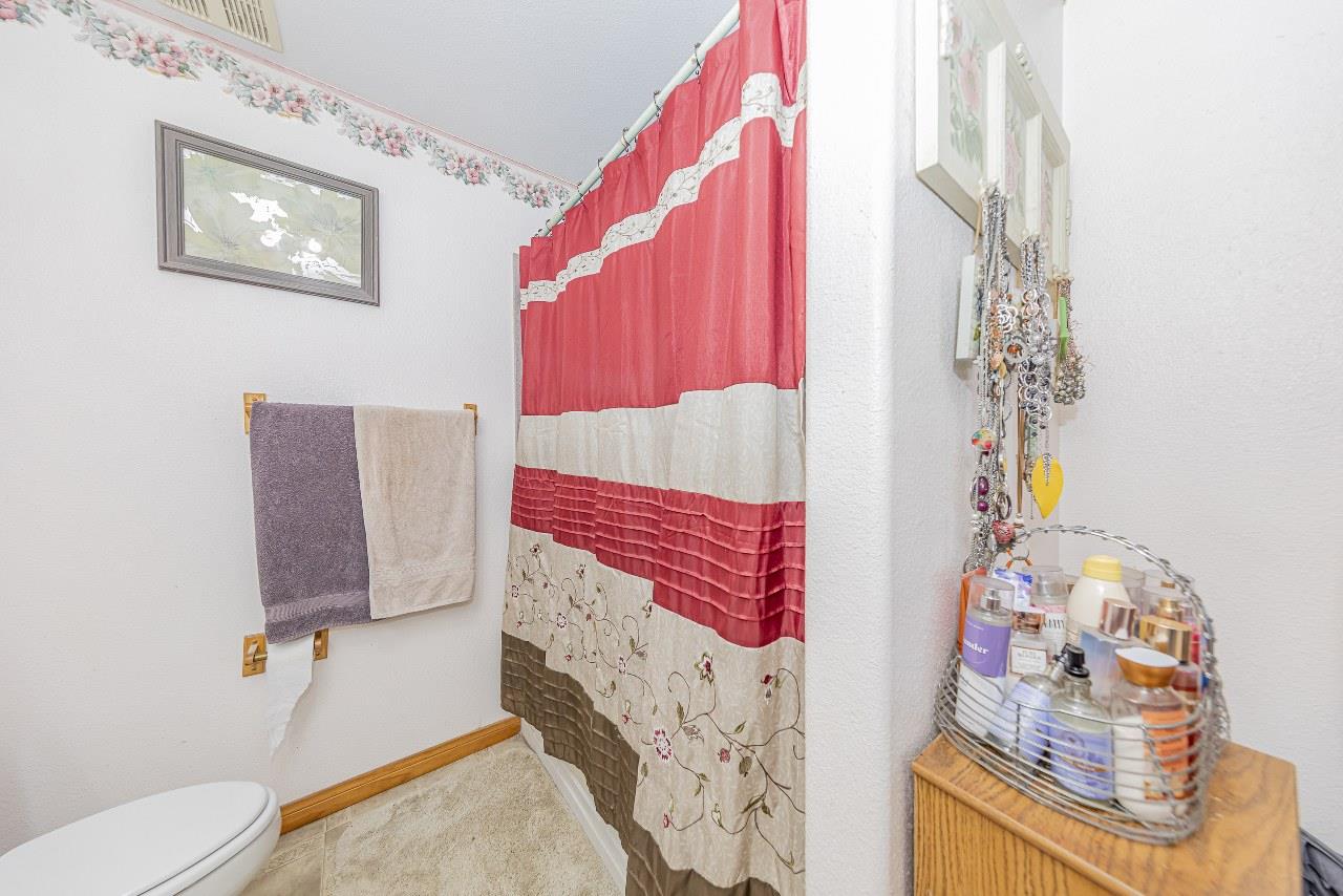 35095 Rough Rider Way Raymond, CA 93653 - Photo 37 of 57 a bathroom with a sink toilet and shower curtain