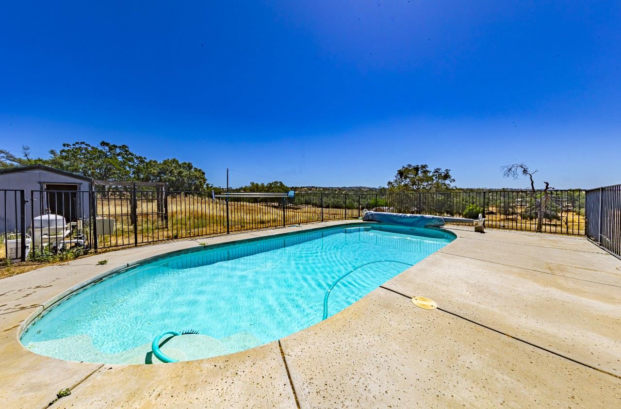 35095 Rough Rider Way Raymond, CA 93653 - Photo 40 of 57 a view of swimming pool with a table and chairs
