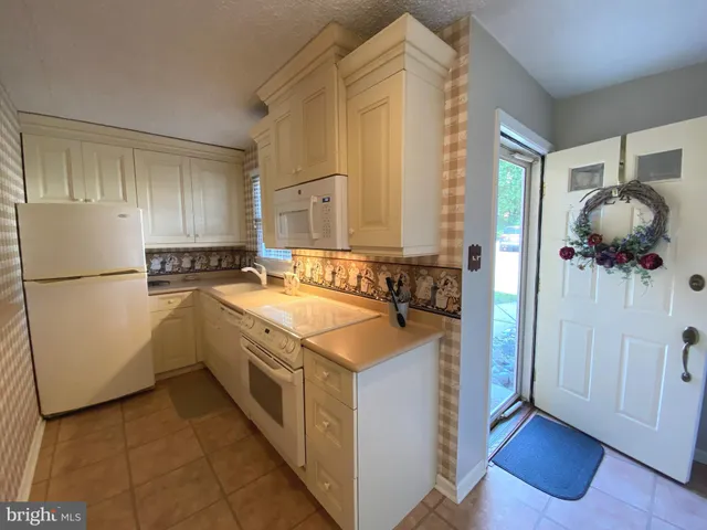 a living room with furniture a flat screen tv and wooden floor