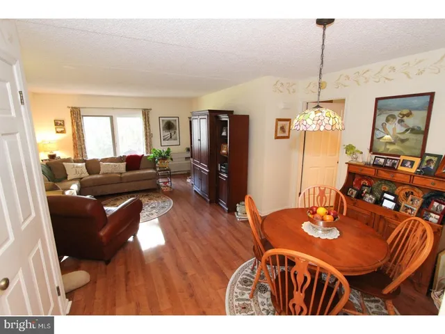 a view of a dining room with furniture and a chandelier