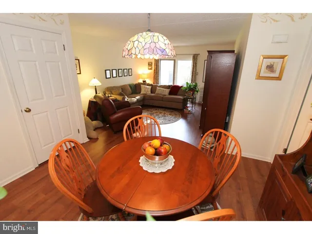 a living room with furniture fireplace and wooden floor
