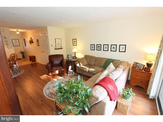 a living room with furniture a window and a flat screen tv