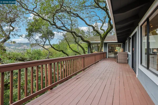 a balcony with wooden floor and outdoor space