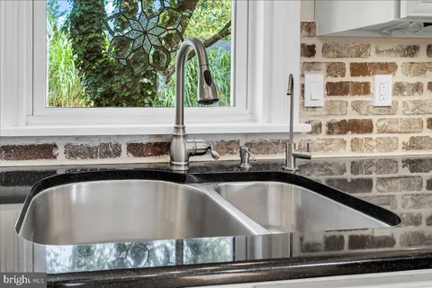 a kitchen with stainless steel appliances a refrigerator and a stove