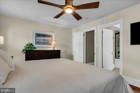 a bathroom with a granite countertop sink a mirror and a shower