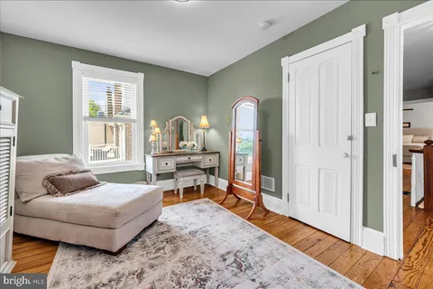 a living room with furniture and a dresser