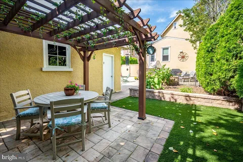 a view of a patio with table and chairs potted plants with wooden floor