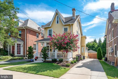a front view of house with a garden