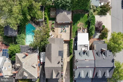 an aerial view of residential houses with outdoor space and street view
