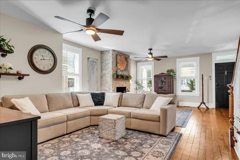 a living room with furniture and a wooden floor