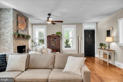 a living room with furniture a fireplace and a flat screen tv