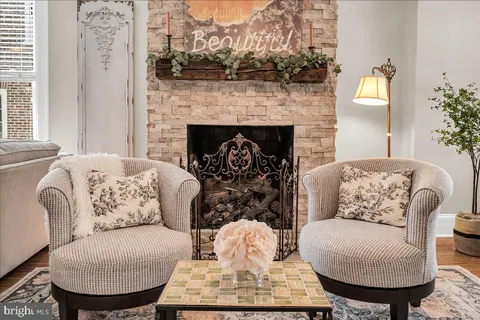 a living room with furniture and a fireplace