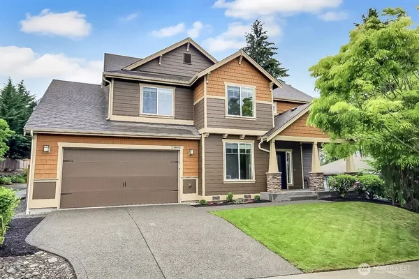 a front view of a house with a yard and garage
